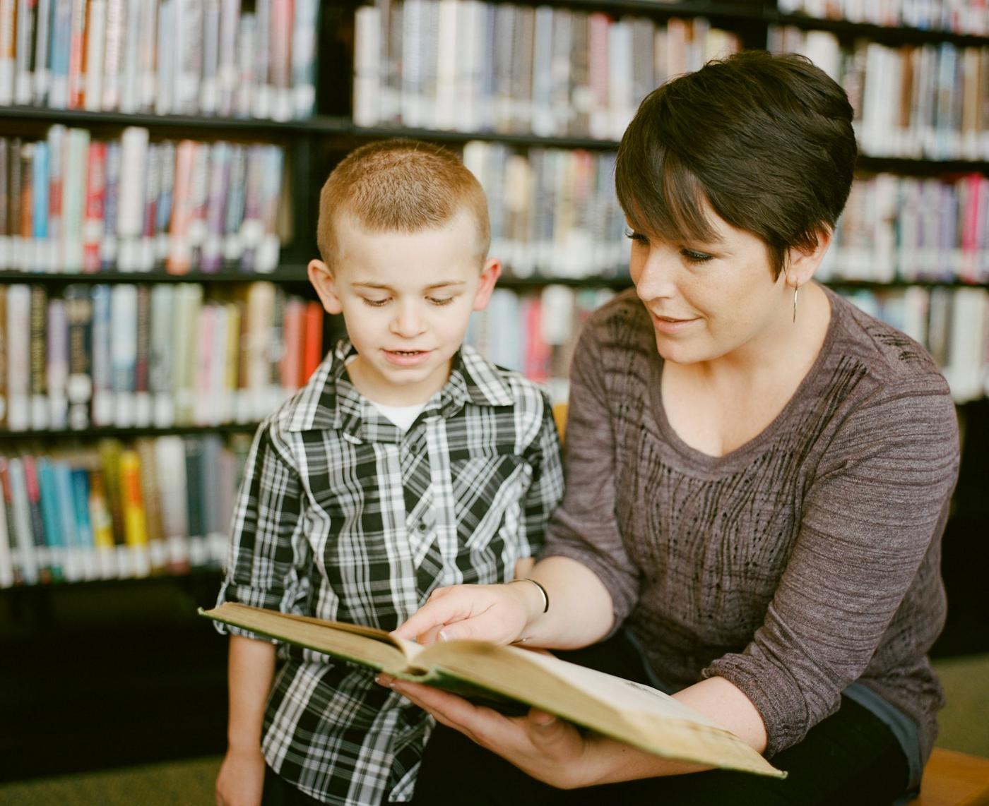 Preview of a school website hero with a guide reading to a child